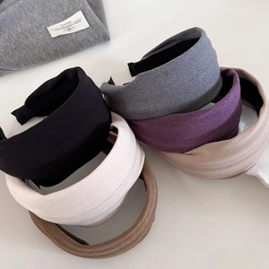 Close-up of wide velvet headbands in various colors with non-slip knit texture details