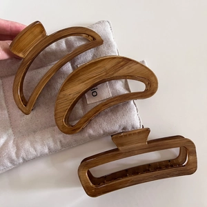 Three-piece large hair claw clip set with dark wood grain texture in semicircular shapes