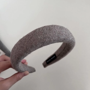Detailed macro view of handmade wool-felt headband with thick grey textured fabric