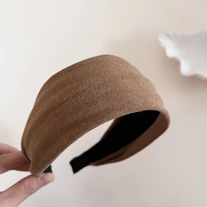 Close-up of brown textured fabric wide headband with anti-slip black inner lining