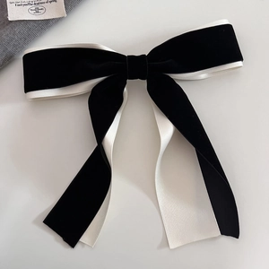 Detail view of French ballet style velvet bow hair clip with double layer black and white fabric