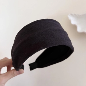 Close-up of the thick black velvet texture on this wide fashion headband for women