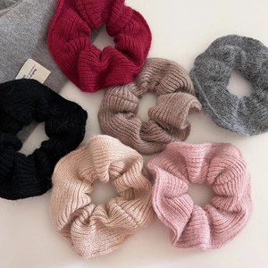 Set of six soft knitted scrunchies in autumn colors like burgundy and rose pink