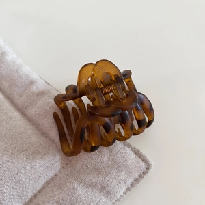 Detail of tortoise shell hair claw clip showing dense teeth and durable metal spring