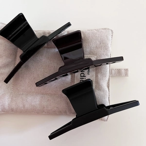 Set of minimalist large hair claws in black matte, glossy brown, and sleek black resin finish
