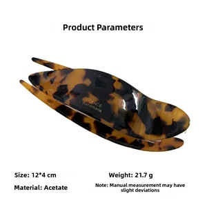 Detailed view of handmade tortoise acetate hair clip showing 12x4cm size and brand mark