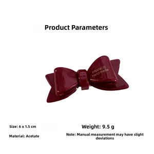 Detail of red acetate bow hair clip showing France Handmade text and 6x1.5cm dimensions
