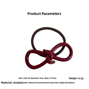 Detail view of burgundy acetate bow hair tie with dimensions 7.5x3cm and 5cm elastic band