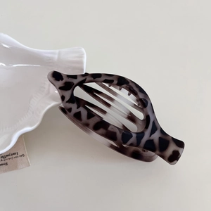 Minimalist black and white leopard oval hair claw clip with a matte finish for women