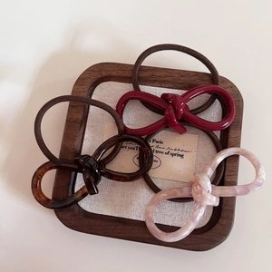 Three-piece set of elegant acetate hair ties with bow knot design in tortoiseshell and burgundy