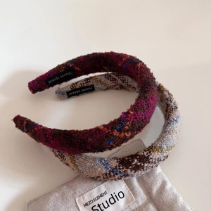 Détail de serre-têtes en tweed avec étiquette fait main sur fond en tissu de lin doux
