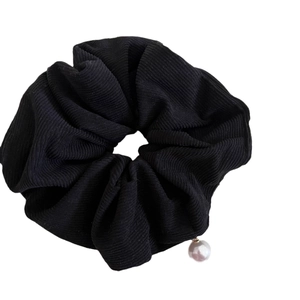 Minimalist black corduroy hair scrunchie with a white pearl pendant for women