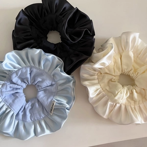 Three-piece set of large satin ruffle scrunchies in black, light blue and cream white