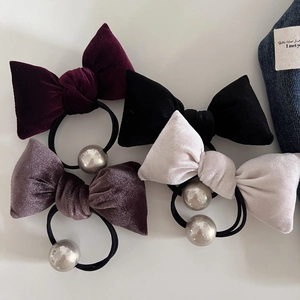 Set of four velvet bow hair ties in burgundy, black, pink, and white with pearl accents