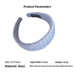 Detail showing knitting texture and dimensions of the navy blue handmade woolen headband
