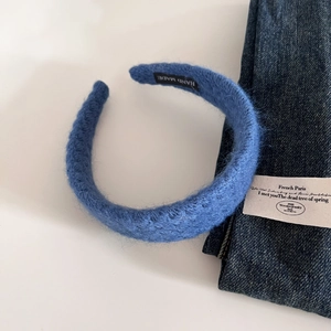 Elegant deep blue knitted wool headband with soft texture and handmade tag for winter style