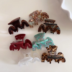 Set of seven acetate hair claw clips in various tortoiseshell and marble patterns