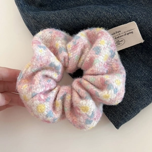 Chunky pink floral plush scrunchie with soft knit fur texture for ponytail styling