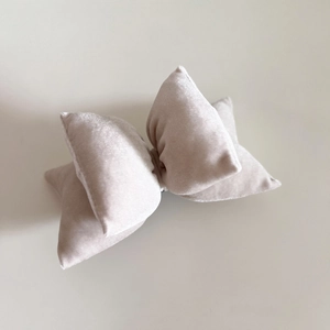 Detail of a plush ivory velvet bow hair clip with double-layered 3D structure