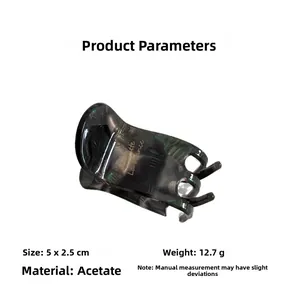 Detail view of acetate hair claw showing 5x2.5cm size and dark marble texture