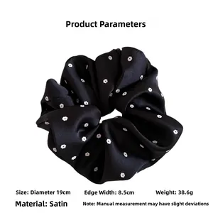 Detail view of 19cm black satin scrunchie with white flower print and size specifications