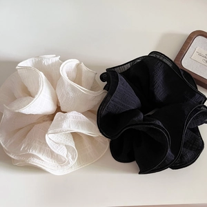 Oversized ruffled scrunchie set in black and white pleat fabric for elegant hairstyling