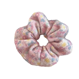 Pink floral plush scrunchie with soft faux fur texture for sweet hair styling
