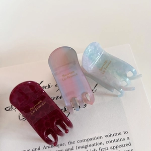 Three elegant acetate hair claw clips in wine red, pastel, and blue marble finish