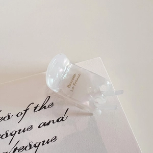 Detail showing high-quality acetate hair claw with elegant golden French lettering