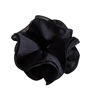 Oversized black tiered organza scrunchie with layered ruffle texture and scalloped edges