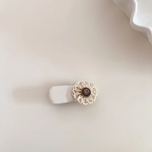 Detail of beaded floral hair clip with silk-wrapped clip and vintage gemstone center
