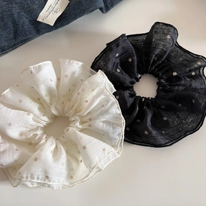 Close-up of large organza hair scrunchies with elegant gold glitter polka dots detail