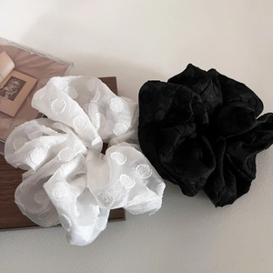 Elegant white mesh scrunchie with embroidered polka dots and a minimalist French aesthetic