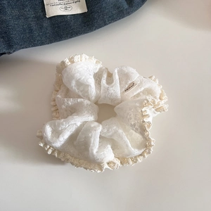 Elegant off-white lace scrunchie with crochet edges and a vintage French style design