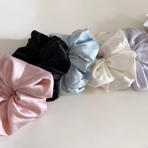 Five pieces set of glossy satin scrunchies in pastel colors for elegant hair styling