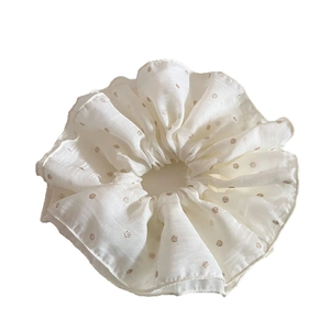 Elegant white mesh scrunchie with gold polka dots and a lightweight pearlescent texture