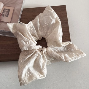 Beige floral embroidered lace scrunchie with intricate patterns and elegant ruffles
