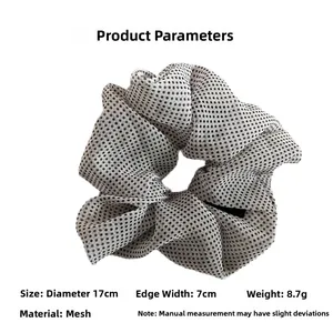 Detail view of large mesh hair scrunchie with black polka dots showing 17cm diameter size