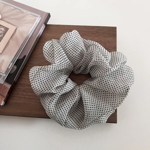 Detail of vintage polka dot mesh scrunchie with semi-transparent organza fabric texture