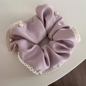 Lavender satin scrunchie with white lace edges and pearl beads for low ponytail style