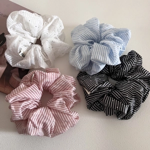 Detailed macro view of four striped scrunchies with crystal rhinestones in multiple colors