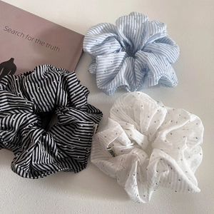 Three-piece set of striped and white scrunchies with silver rhinestones on white background