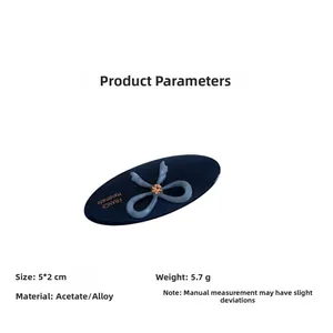 Detail view of oval acetate hair clip with blue bow and dimensions 5x2cm plus alloy base