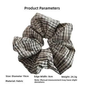 Detail shot of black and white plaid scrunchie with 19cm diameter and fabric texture