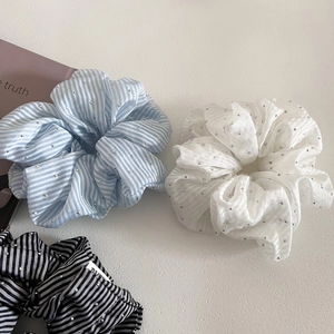 Detailed view of striped scrunchies with sparkling rhinestones and textured chiffon fabric