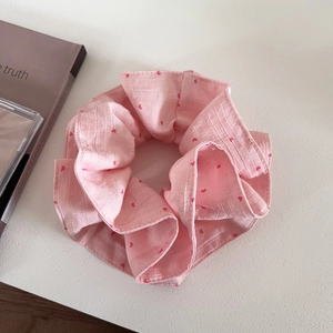 Pink heart print scrunchie with soft fabric texture for stylish bun hair accessories