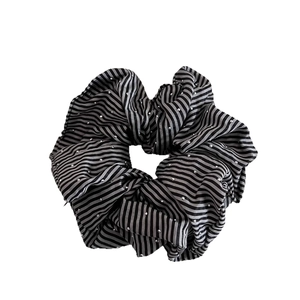 Striped black and white scrunchie with sparkling glitter dots for women's hair styling
