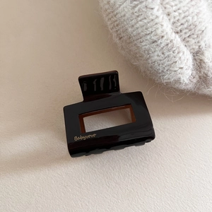 Elegant rectangular acetate hair claw in deep chocolate brown with golden logo detail