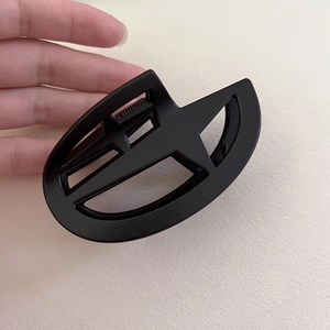 Minimalist matte black starburst hair claw clip with geometric hollow design