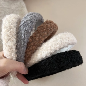 Five assorted colors of plush faux shearling headbands for autumn and winter outfits